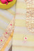 Close-up of Gota Patti work on yellow Kota Doria fabric with golden floral motifs and red highlights.