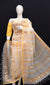 Model showcasing yellow Kota Doria Gota Patti dress material with gold and red floral embroidery.