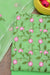 Close-up of Green Kota Doria Dress Material showcasing intricate pink and green floral embroidery on a checkered fabric