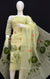 Mannequin showcasing hand-painted pale olive Kota Doria dress material with intricate orange and green floral motifs and a matching dupatta.