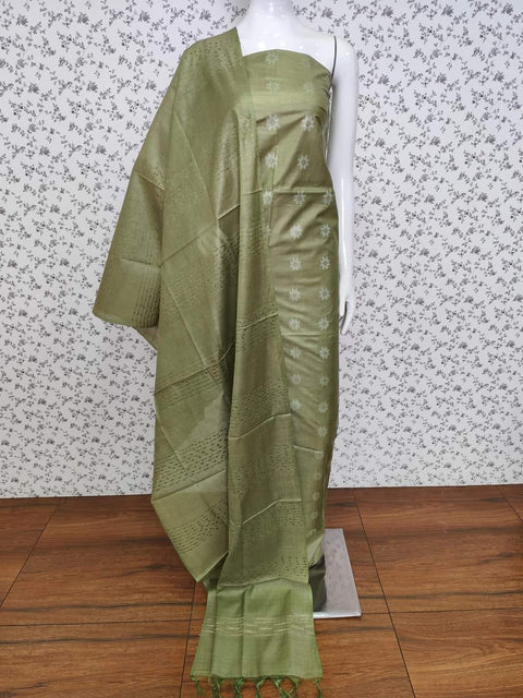 Olive Green Semi Tussar Silk Dress Material with intricate woven motifs, paired with a matching dupatta and plain bottom fabric. Perfect for office wear, festive occasions, and casual outings.