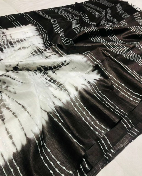 Black and white tie-dye fabric with abstract patterns on a plain background